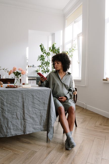 A person sitting comfortably with eyes closed in a calm, modern living room