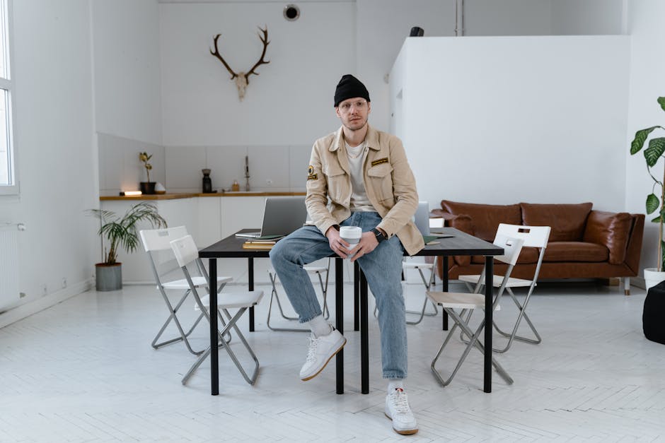A stylish workspace with a laptop, plants, and a cup of coffee
